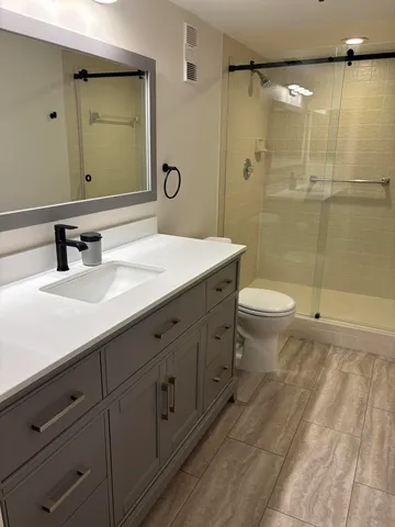 a bathroom with a double vanity sink and mirror