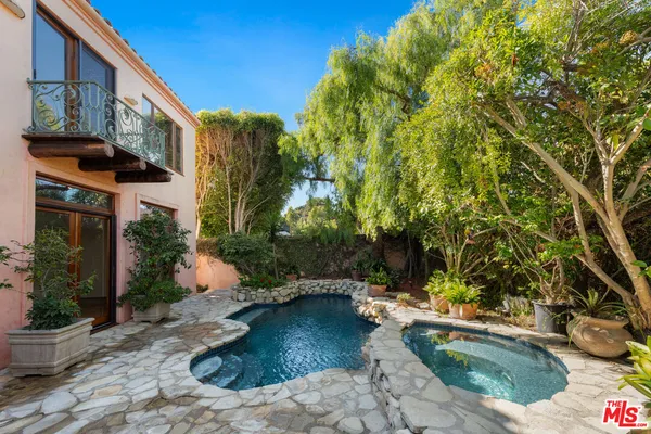 a view of a backyard with plants and a patio