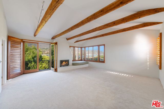 a view of an empty room with windows