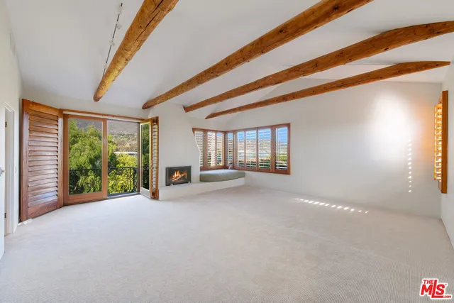 a view of an empty room with windows