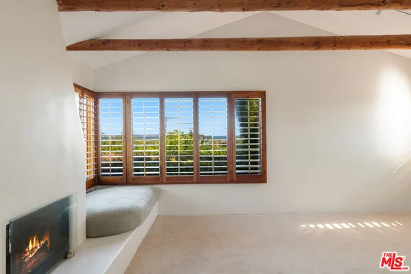 a view of an empty room with a fireplace