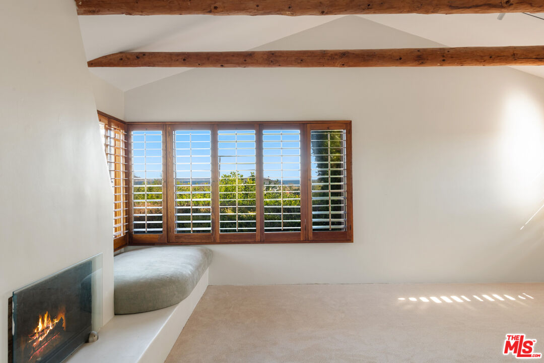 23351 Malibu Colony Road, Unit 108A Malibu, CA 90265 - Photo 17 of 27 a view of an empty room with a fireplace