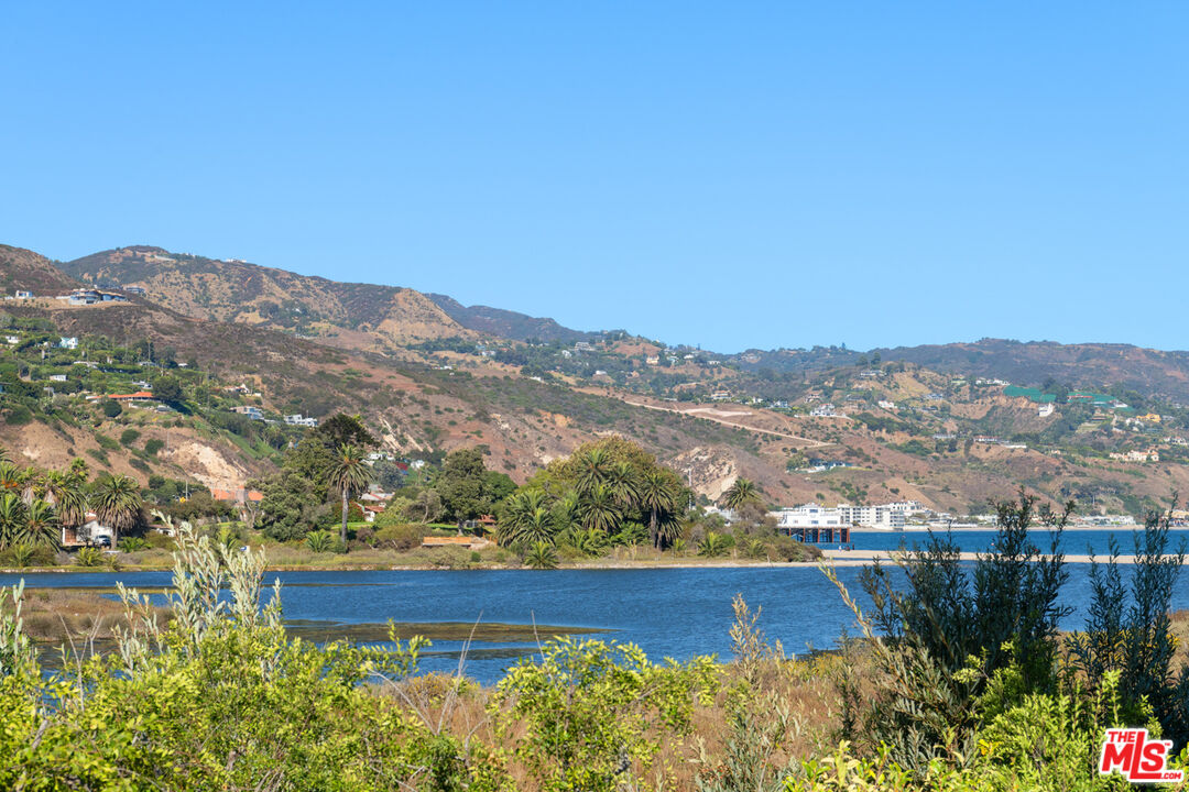 23351 Malibu Colony Road, Unit 108A Malibu, CA 90265 - Photo 19 of 27 a view of a lake with a mountain