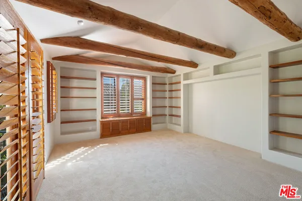 a view of an empty room and a window