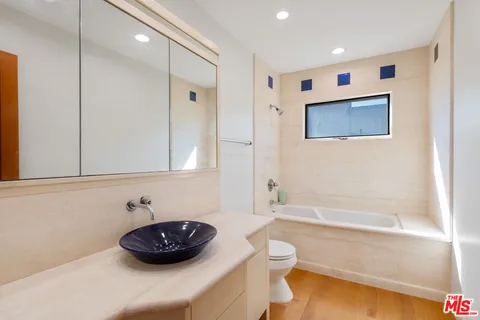 a bathroom with a sink a toilet and bathtub