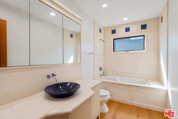 a bathroom with a sink a toilet and bathtub