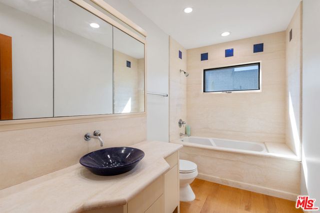 a bathroom with a sink a toilet and bathtub