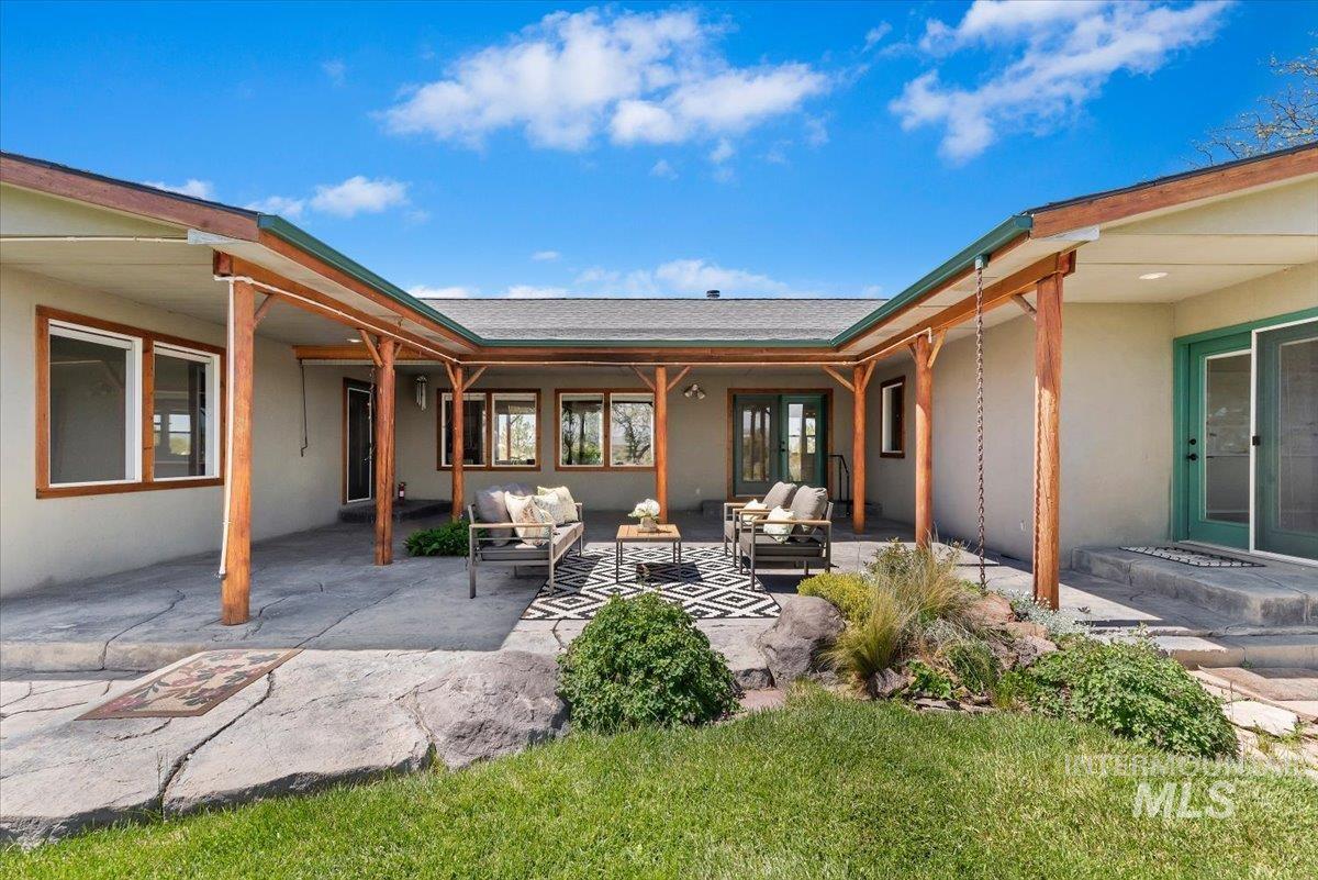 147 East Indian Crk Road Boise, ID 83716 - Photo 30 of 43 Expansive covered patio featuring wood support beams and a stamped concrete surface