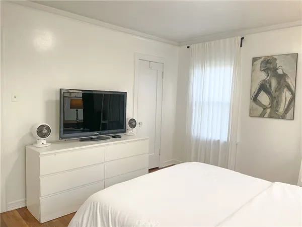 a bedroom with a bed and a flat screen tv