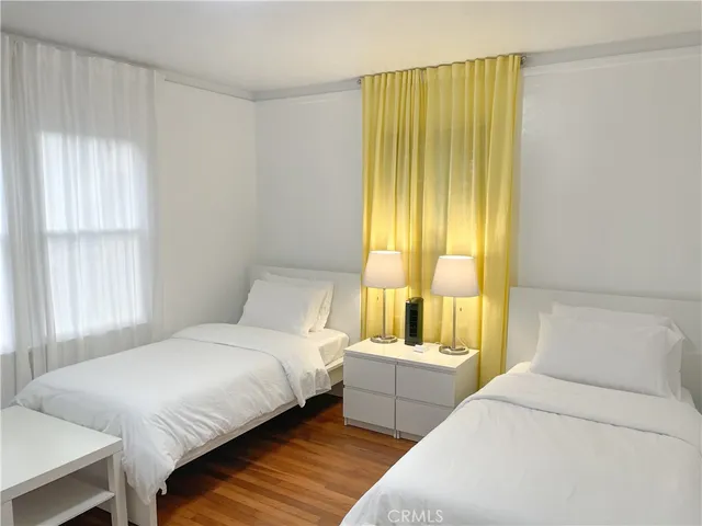 a bedroom with a bed and a large window