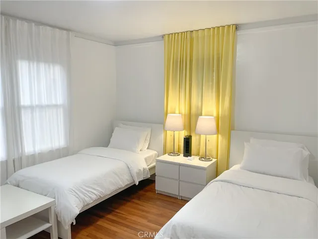 a bedroom with a bed and a large window