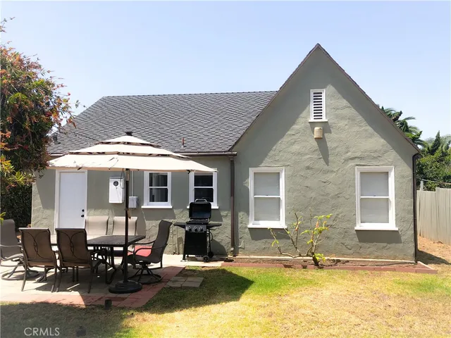 a view of a house with swimming pool and sitting area