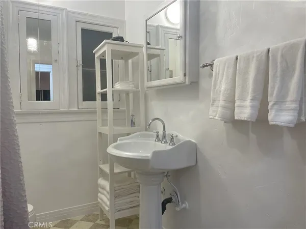 a bathroom with a sink a mirror and a shower