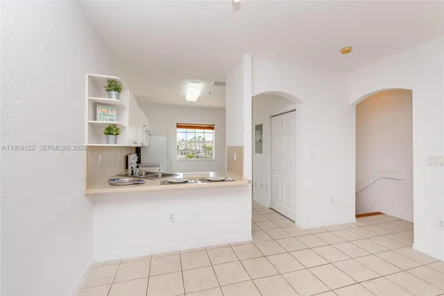 a kitchen with a sink cabinets and window