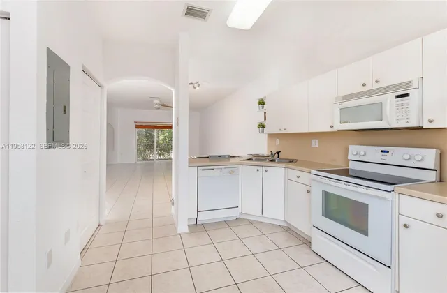 a kitchen with cabinets and appliances