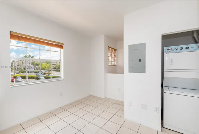 a view of a kitchen with a refrigerator washer and a window