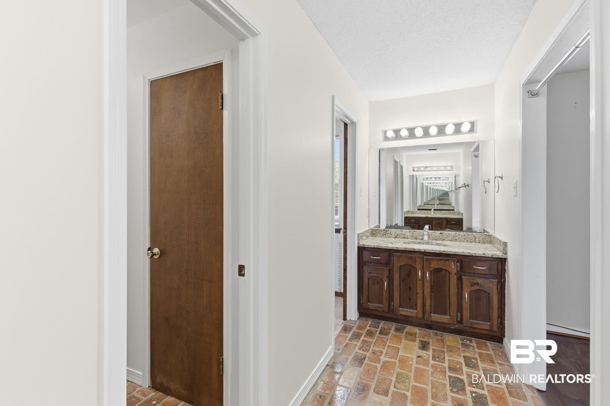 9215 Shiloh Drive Mobile, AL 36695 - Photo 20 of 32 Full bathroom with brick floors, vanity, and a textured ceiling