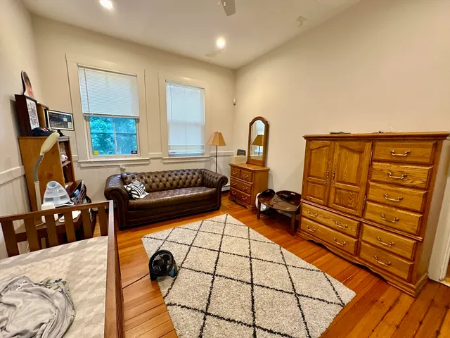 a bedroom with furniture and a window