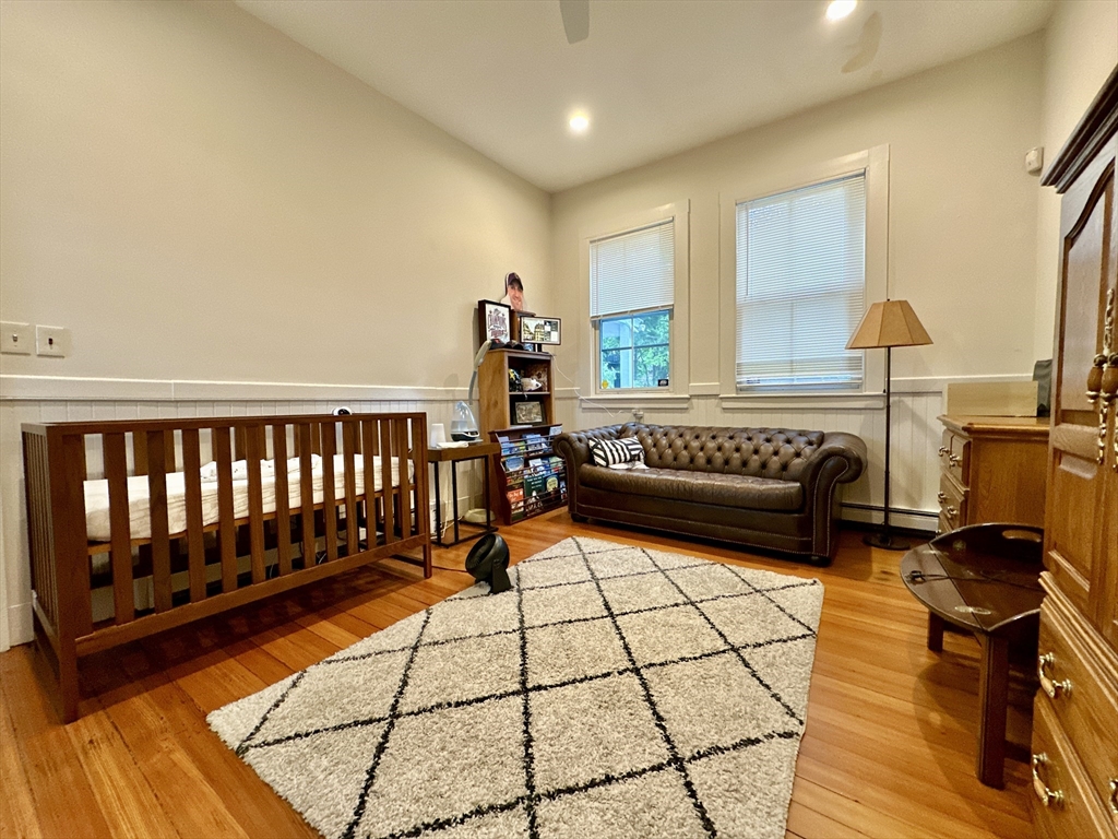61 Pond Street, Unit 1 Boston, MA 02130 - Photo 14 of 18 a living room with furniture rug and a table