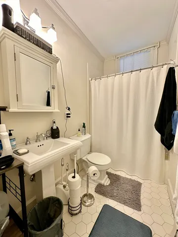 a bathroom with a sink toilet and mirror