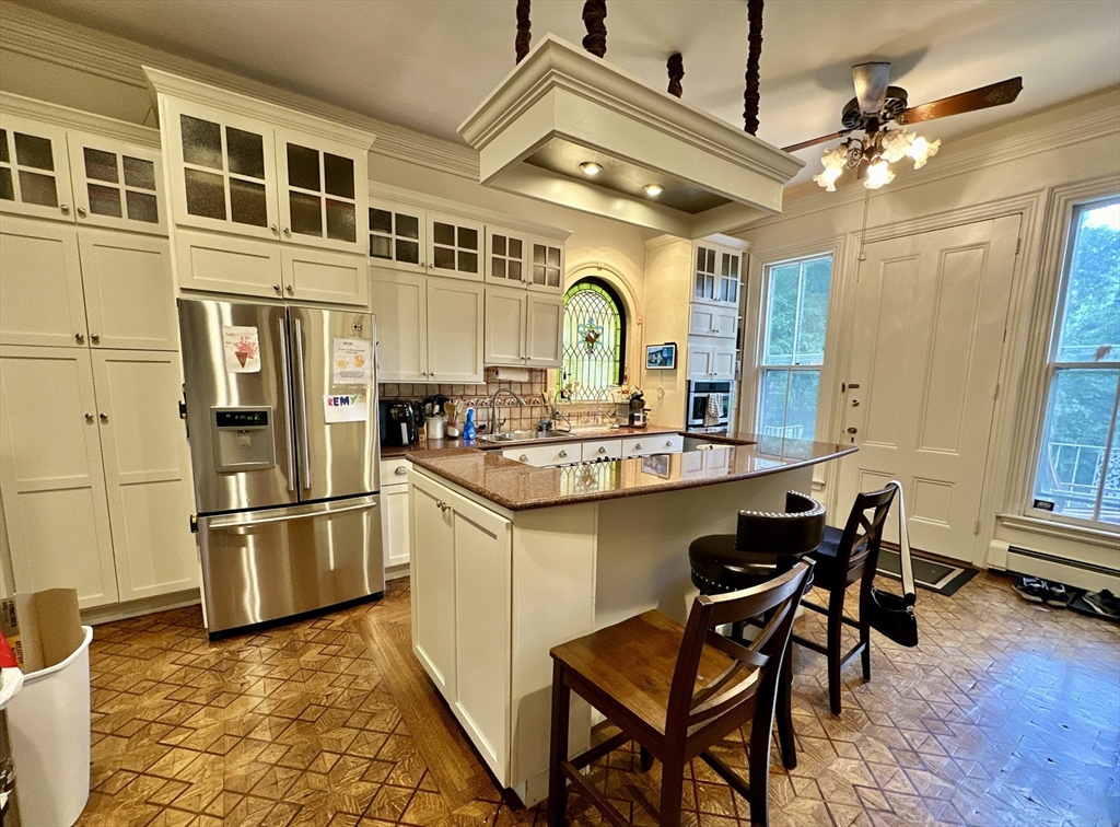 61 Pond Street, Unit 1 Boston, MA 02130 - Photo 2 of 18 a kitchen with stainless steel appliances granite countertop a stove and a refrigerator