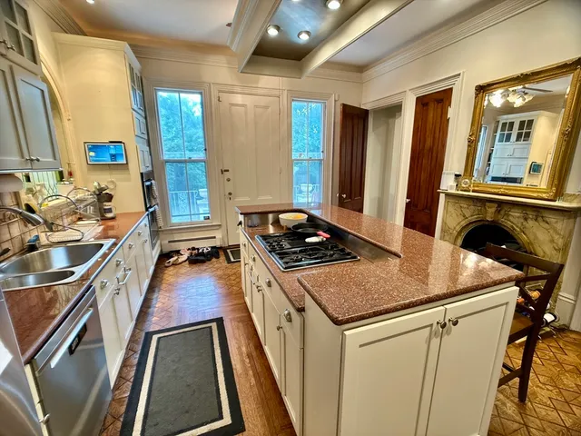 a kitchen that has a sink and a stove