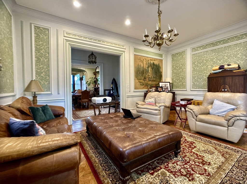 61 Pond Street, Unit 1 Boston, MA 02130 - Photo 9 of 18 a living room with furniture and a chandelier