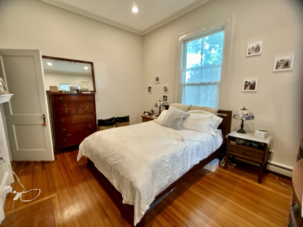 61 Pond Street, Unit 1 Boston, MA 02130 - Photo 10 of 18 a bed sitting in a bedroom next to a window