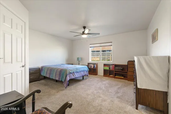 a bedroom with a bed dresser and a window