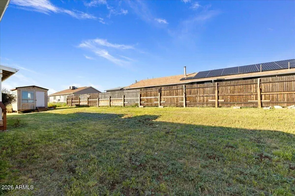 a view of an house with backyard space and balcony