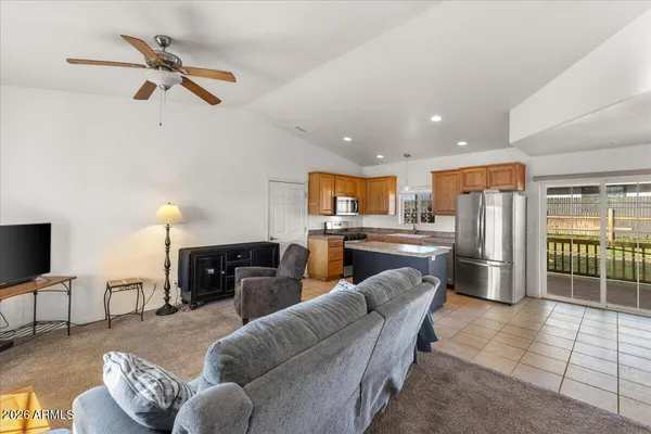 a living room with furniture kitchen and a fireplace