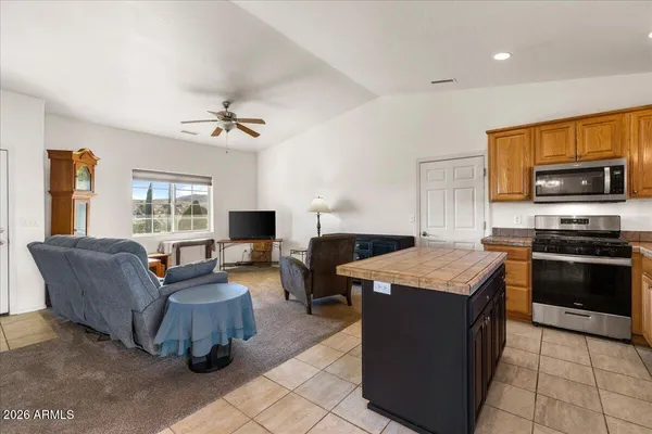 a living room with granite countertop furniture and a flat screen tv
