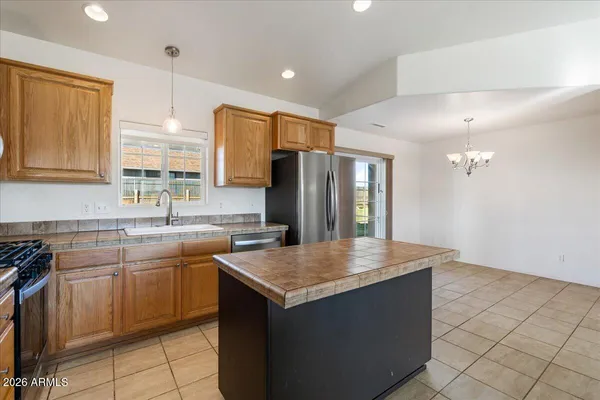 a kitchen with a sink refrigerator and microwave