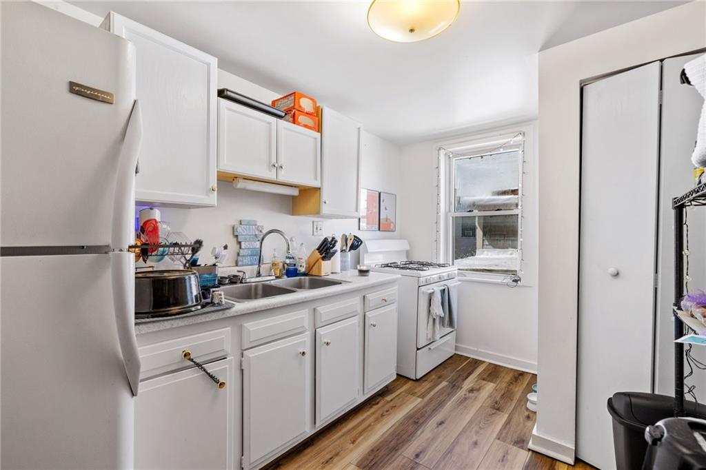 80 South 12th Street Pittsburgh, PA 15203 - Photo 14 of 43 a kitchen with white cabinets and white appliances