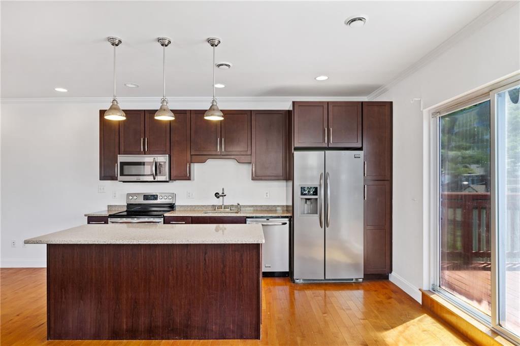 80 South 12th Street Pittsburgh, PA 15203 - Photo 24 of 43 a kitchen with kitchen island a counter top space a sink stainless steel appliances and cabinets