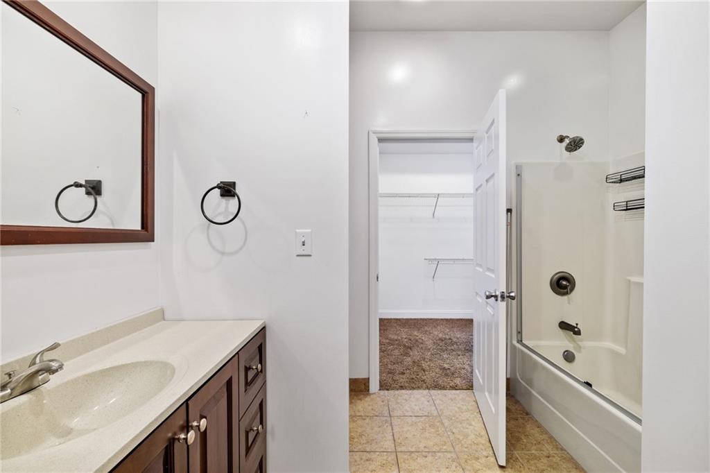80 South 12th Street Pittsburgh, PA 15203 - Photo 31 of 43 a bathroom with a granite countertop sink mirror and shower