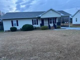 a view of a house with backyard and porch