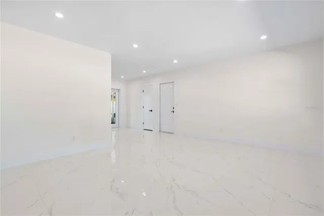 a view of a kitchen with a refrigerator and a sink