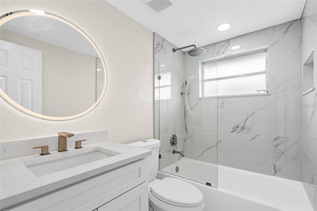 5626 Moog Road Holiday, FL 34690 - Photo 24 of 38 a bathroom with a sink a toilet and shower