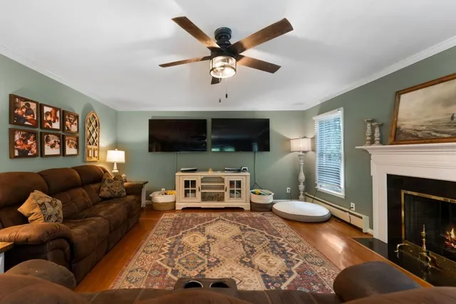 a kitchen with stainless steel appliances granite countertop a refrigerator a sink dishwasher a stove and white countertops with wooden floor