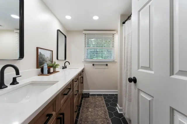 a living room with furniture a air conditioner and a window