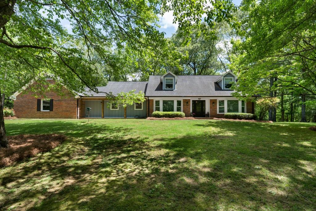 311 Herring Road Armuchee, GA 30105 - Photo 2 of 66 a front view of a house with a garden