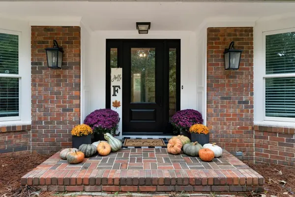 a view of a livingroom with wooden floor and a ceiling fan