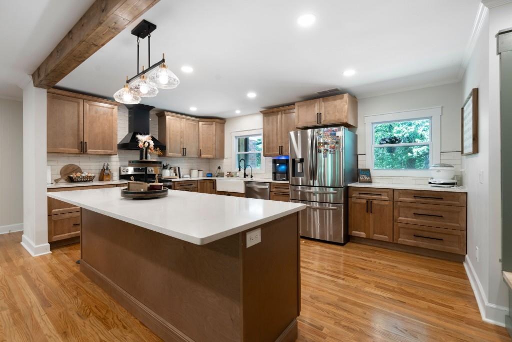 311 Herring Road Armuchee, GA 30105 - Photo 23 of 66 a kitchen with stainless steel appliances kitchen island granite countertop a stove refrigerator and a sink