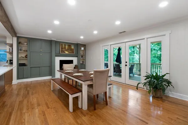 a living room with furniture a flat screen tv and a floor to ceiling window
