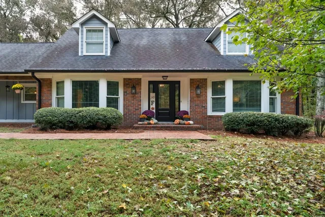 a view of a brick house with a yard