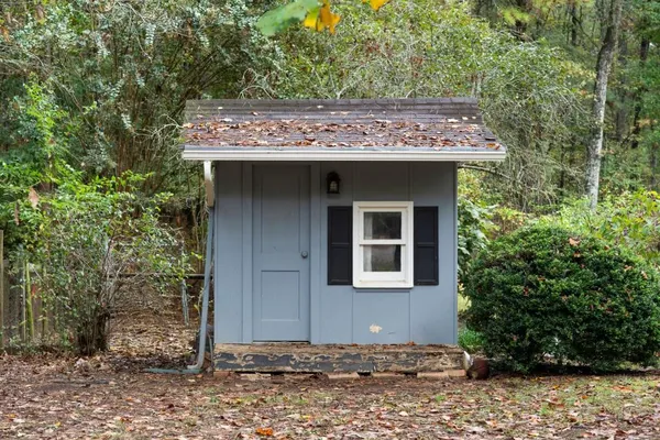 a view of a bedroom with furniture and windows