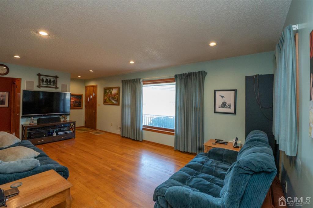671 Ridge Road Monmouth Junction, NJ 08852 - Photo 8 of 28 a living room with furniture and a flat screen tv