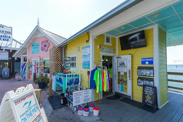 a front view of multi story residential apartment building with yard and sign board