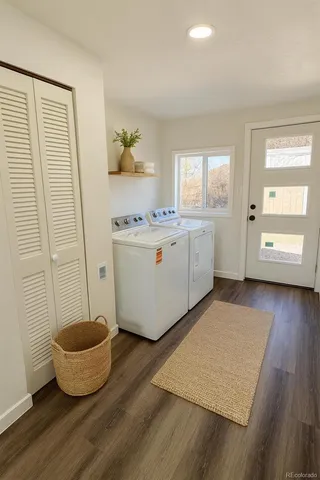 a furnished livingroom with windows and wooden floor